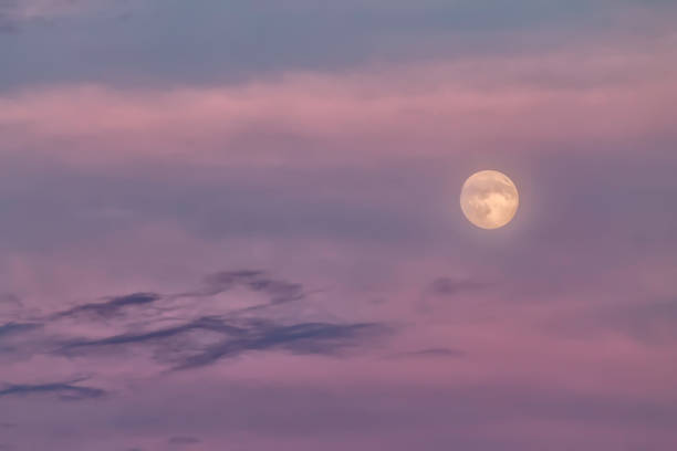 istock Full bright moon on a colorful sky 900179586