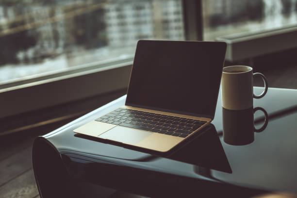 istock Cup of coffee and laptop. 900183984
