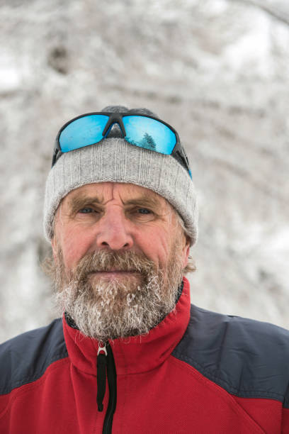 Portrait of a Senior Man Cross-Country Skiing, Europe Portrait of a senior man with beard and mouctaches in winter cross-country skiinng, Alps, Slovenia, Europe. primorska white sport nature stock pictures, royalty-free photos & images