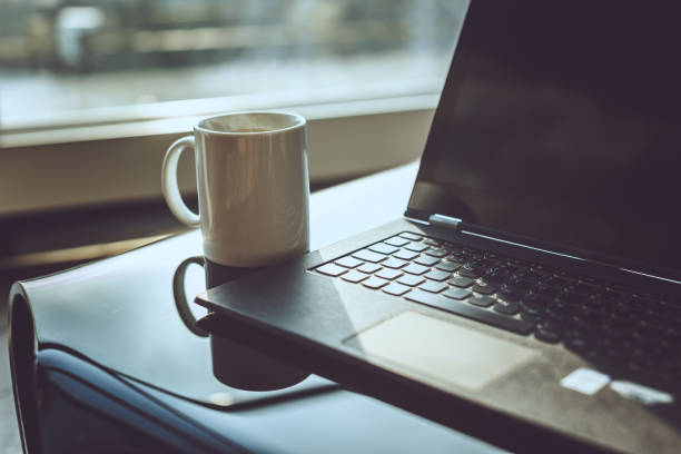 istock Cup of coffee and laptop. 900188530