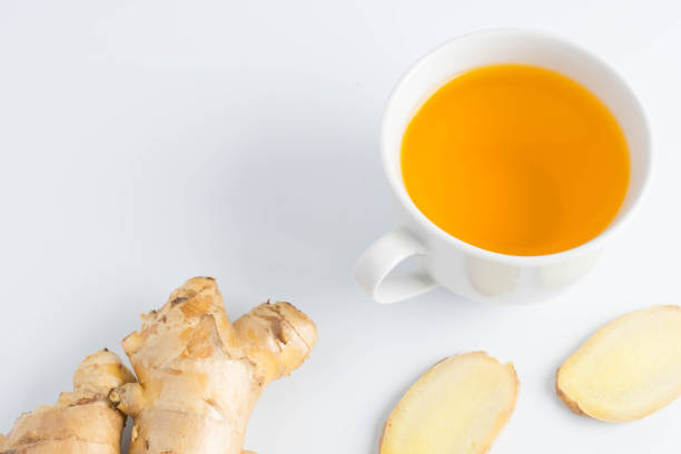istock hot ginger tea ginger ale ginger beer in glass with ginger slice on white background 900189262