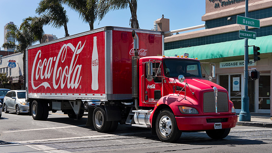 San Francisco, California, USA - September 22, 2017: famous red large Coca Cola truck stopped on a road that goes towards The Fisherman's Wharf