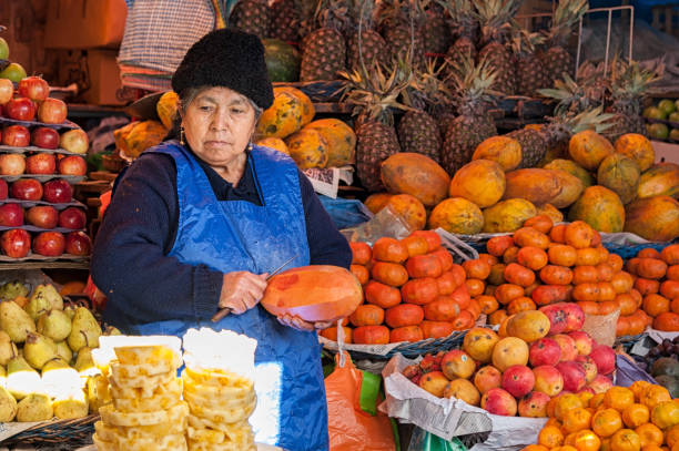 unidentified bolivian sellers at fruit stalls at central market in sucre, bolivia - merced county imagens e fotografias de stock