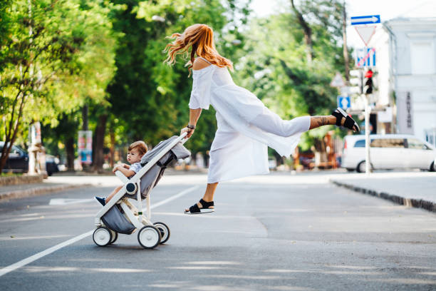 istock mom with a stroller crosses the road 900199114