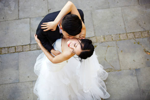 istock young asian adults dancing in wedding dress 900200010