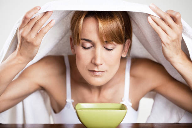 istock woman inhaling over a bowl 900202802