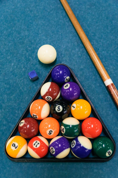 istock Billiard balls an cue on billiards table. 900203348