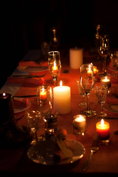 Festive composition with candles and plates. Table decoration. A beautiful table setting, red table cloth, tablecloth in the box. Christmas dinner. A white plate with a nice napkin on the table