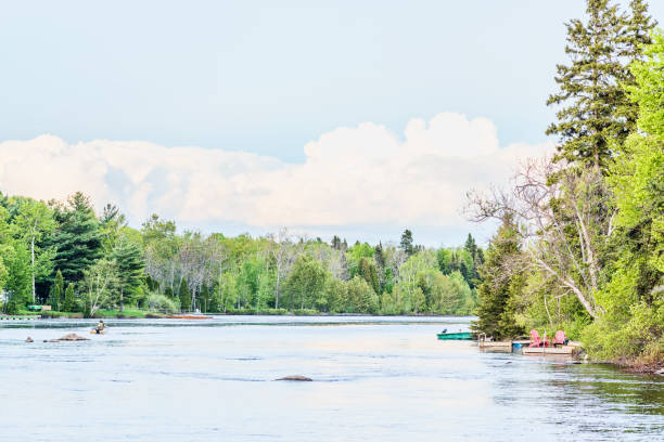 Chicoutimi river in Saguenay, Quebec, Canada with riverfront houses