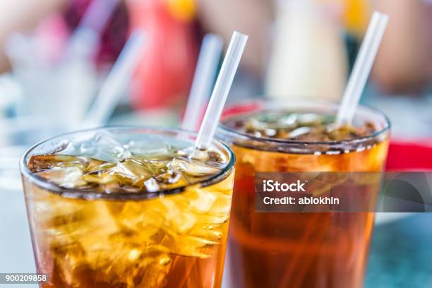Macro Closeup Of Iced Tea Or Soda With Ice Cubes And Straw In Glass Stock Photo - Download Image Now