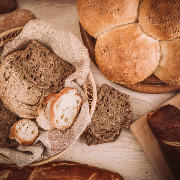 istock Many mixed baked breads and rolls on rustic wooden table 900209866