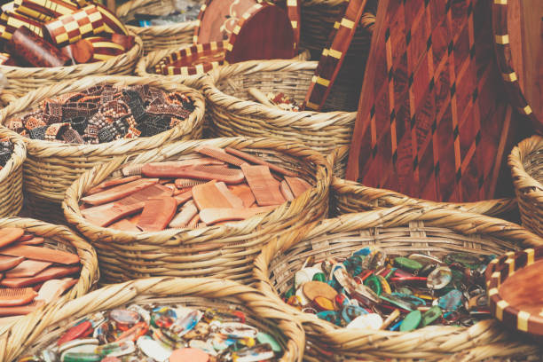 Stack of empty rattan baskets sold outside on a market