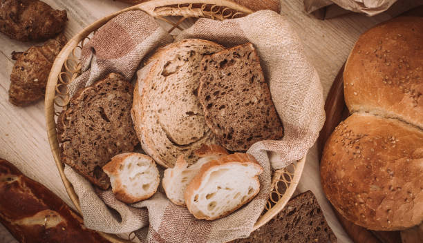 istock Many mixed baked breads and rolls on rustic wooden table 900210338