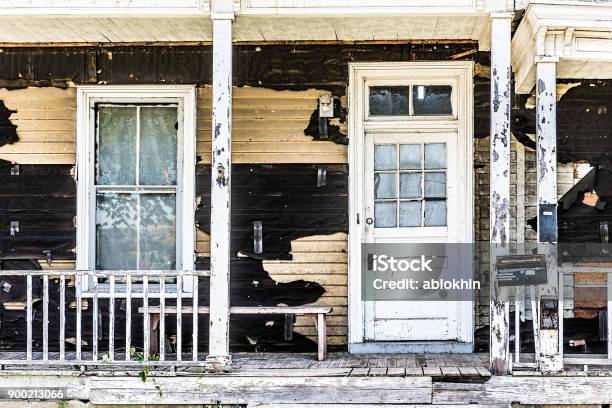 Old Abandoned Weathered Wooden House With Porch Entrance Peeling Paint Dirty Windows Stock Photo - Download Image Now