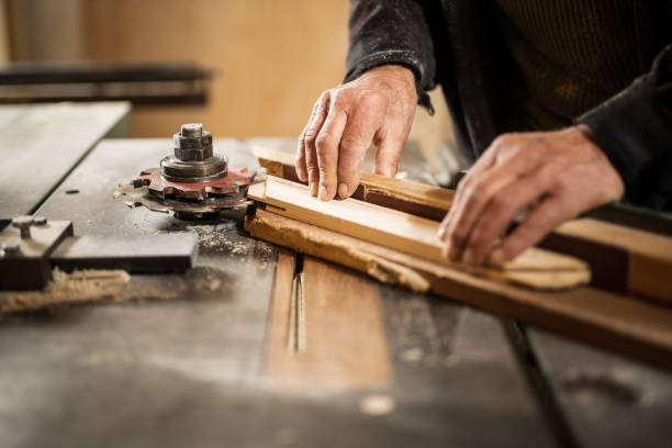 istock Senior man cutting wood 900214064