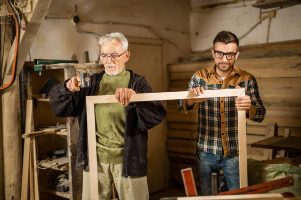 istock Young and senior carpenter 900216462
