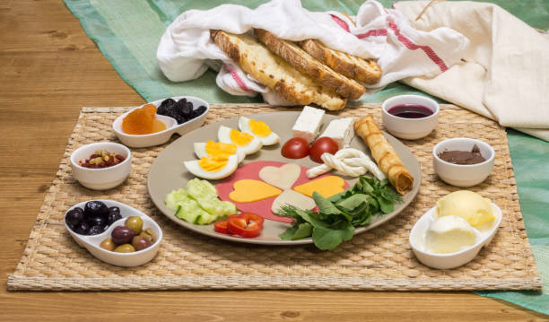 Close up of traditional Turkish breakfast served with cheese, salami, boiled egg, tomato, cucumber and toasted bread Close up of traditional Turkish breakfast served on porcelain plate with cheese, salami, boiled egg, tomato, cucumber and toasted bread egg cherry tomato rye stock pictures, royalty-free photos & images