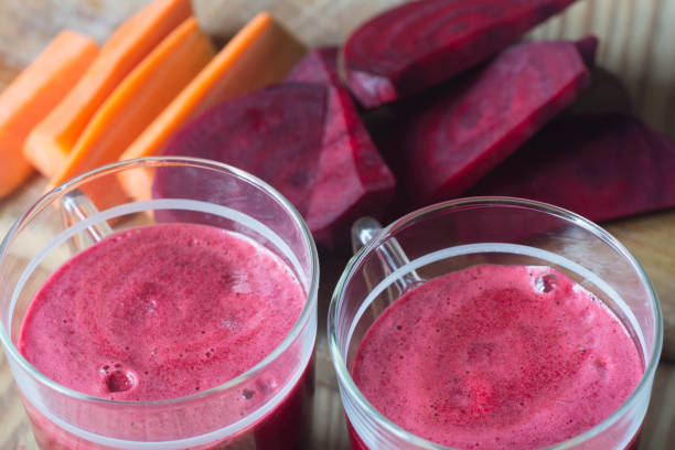 glass of fresh beet and carrot juice stock photo