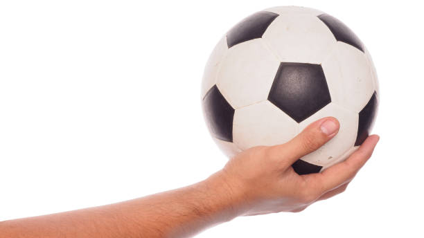 istock male hand holding football 900239302