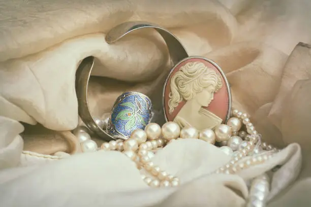 Woman's Jewellery. Vintage jewellery with cameo brooch, silver ring and genuine pearls