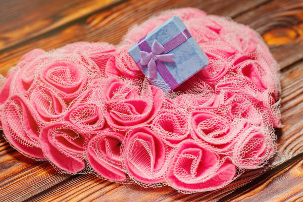 Vintage pink rose and Pearl Necklace on wooden background. Love concept.