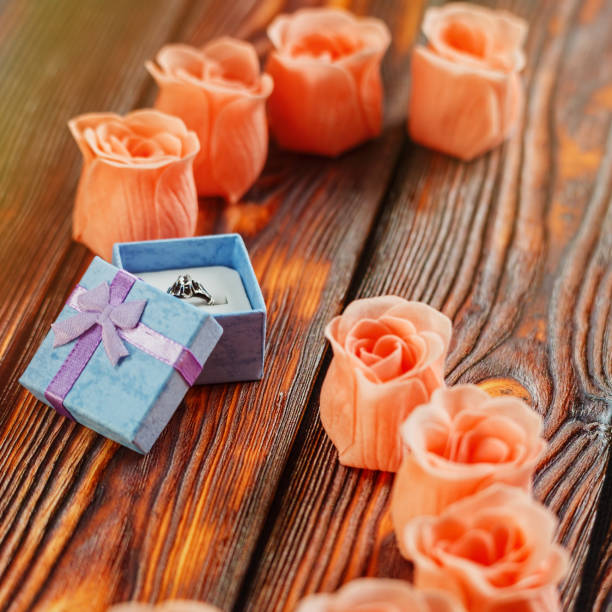 istock Gem ring in jewelry box and some rose blossoms 900259536