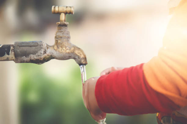istock Stream of clean water pouring into infant hands. 900264850
