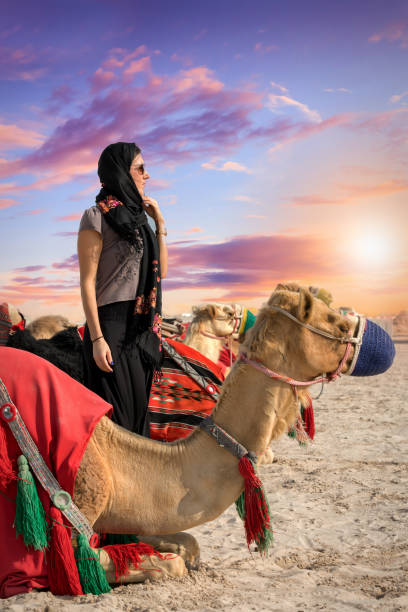 Photo of Woman with a camel in the desert of Qatar