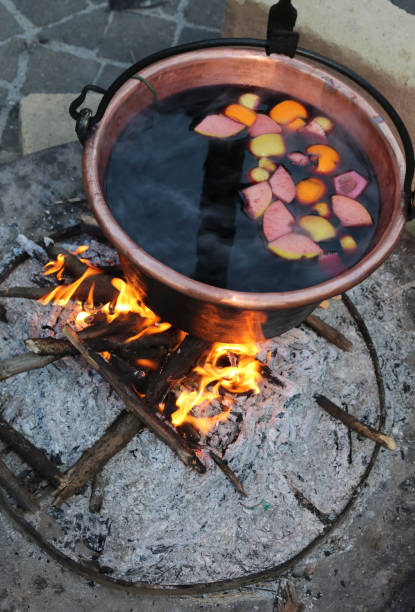 istock hot MULLED WINE on the big cauldron over the bonfire during the winter break 900273084