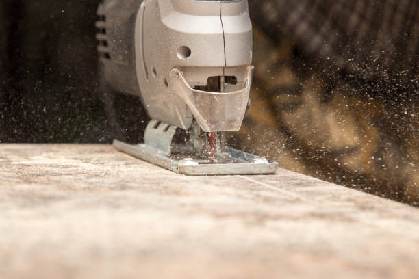 istock Master cuts wood with a jig saw 900284974