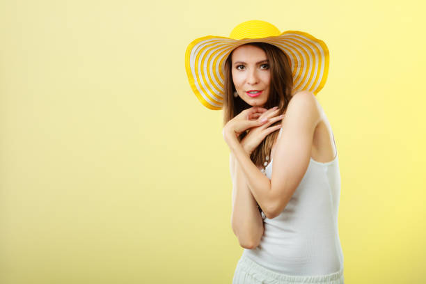 istock Woman in big yellow summer hat. 900313036