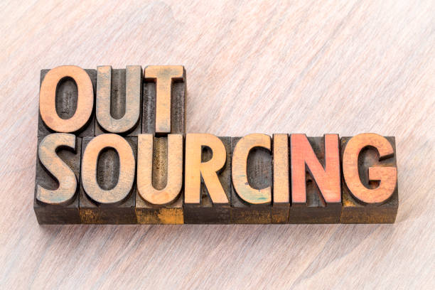 istock outsourcing word abstract in wood type 900313416