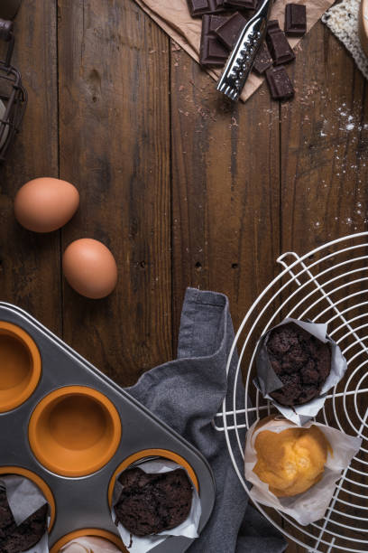 istock Ingredients to cooking muffins in a rustic setting on wooden table with copyspace. 900321070