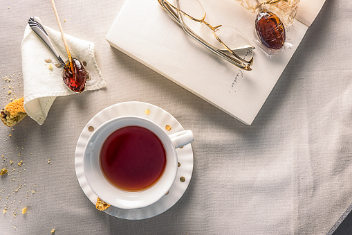 wide high angle on a cup of tea, book and eyeglasses