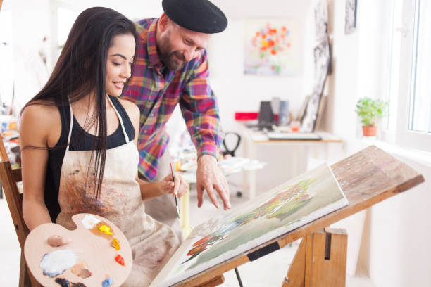 istock Fine art student working with teacher in atelier 900348362