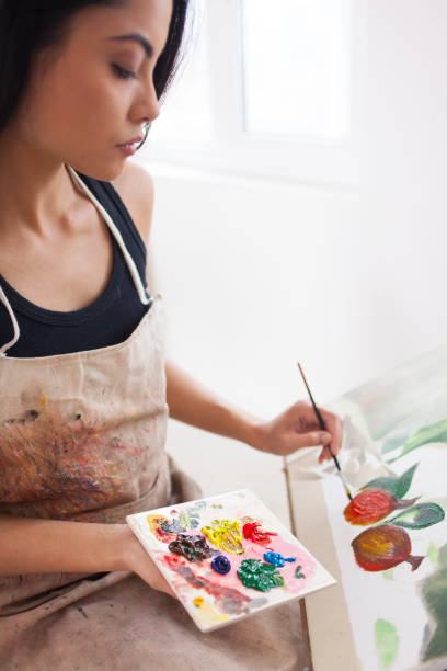 istock Female artist working in studio 900348364