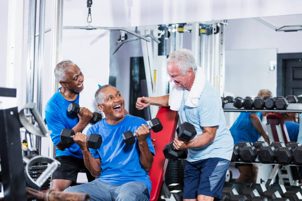 istock Three senior multi-ethnic men working out at gym talking 900349058