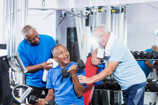 istock Three senior multi-ethnic men working out at gym talking 900349066