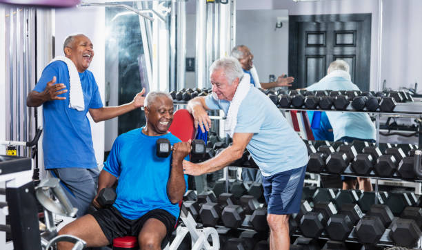 istock Three senior multi-ethnic men working out at gym talking 900349388