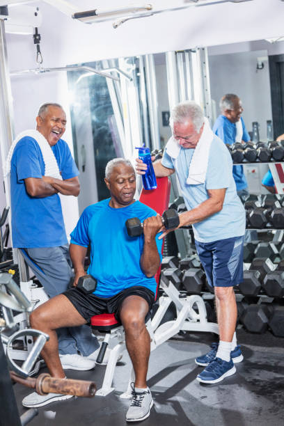 istock Three senior multi-ethnic men working out at gym talking 900349664