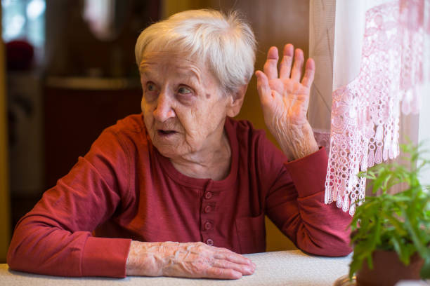 istock Elderly woman gesturing while sitting at the table. 900352962