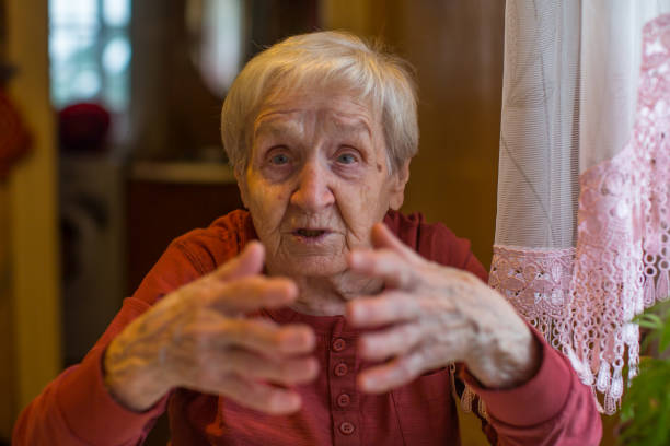 istock Elderly woman gesturing while sitting at the table. 900352974