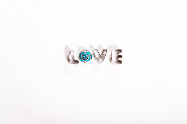 Metal Word LOVE with Blue Jewell on white background