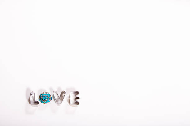 Metal Word LOVE with Blue Jewell on white background