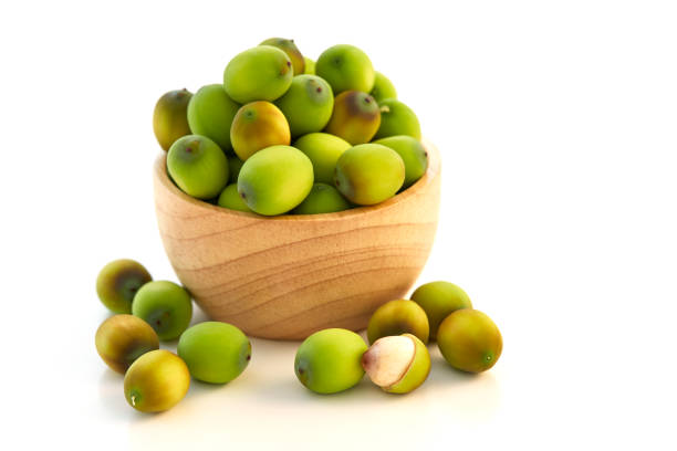 istock Lotus seeds put in a wooden cup on a white 900367050