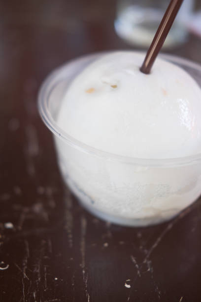 istock Fresh coconut juice on wooden floor 900378816