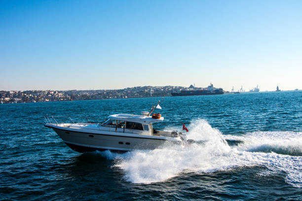 Istanbul, Turkey - July 1, 2023: Boat is leaving track in Istanbul. Two man on the boat.