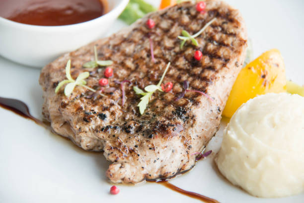 istock Beef steak with sauce on white plate 900392446