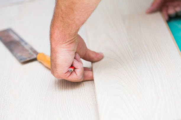 istock Installing laminate floor with wooden texture 900392738