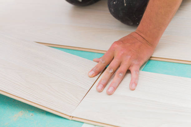 istock Installing laminate floor with wooden texture 900392850